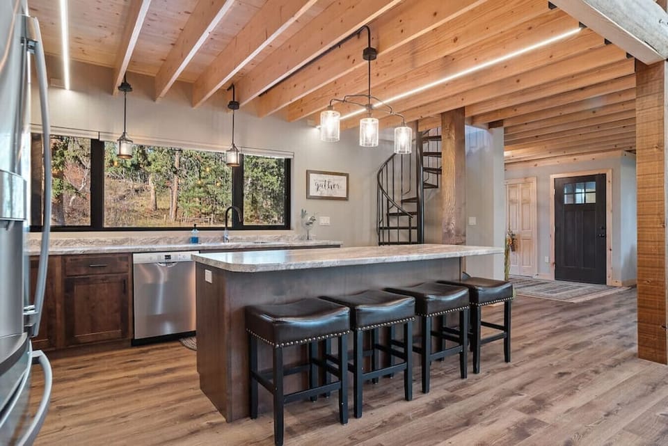 Charming kitchen setup with a sleek countertop and four chic chairs, perfect for a family meal