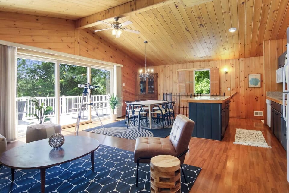 Dining area with large windows and deck access
