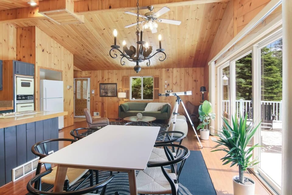 Open dining space with vaulted wood ceilings and natural light