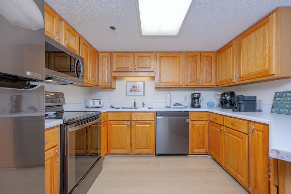 Shiny appliances and warm wood cabinets surround you as you prepare fresh meals in the kitchen