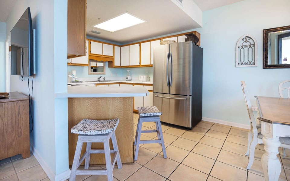Cook and gather in the spacious kitchen, featuring stainless steel appliances and a cozy dining area for meals together