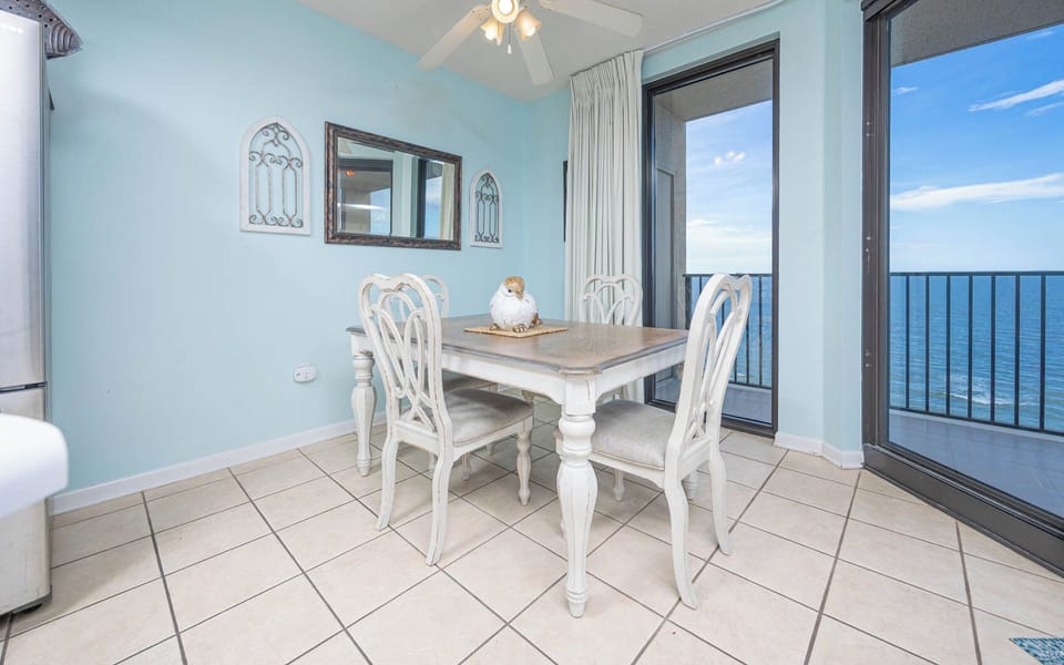 Dine at the charming table, surrounded by light blue walls and enjoying sweeping beach views through large windows