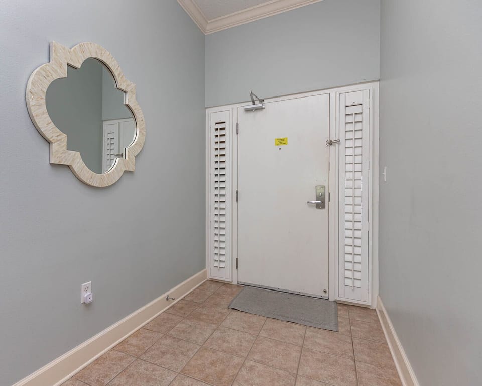 Step into a welcoming foyer, where you can admire the stylish mirror and feel the comfort of your coastal retreat