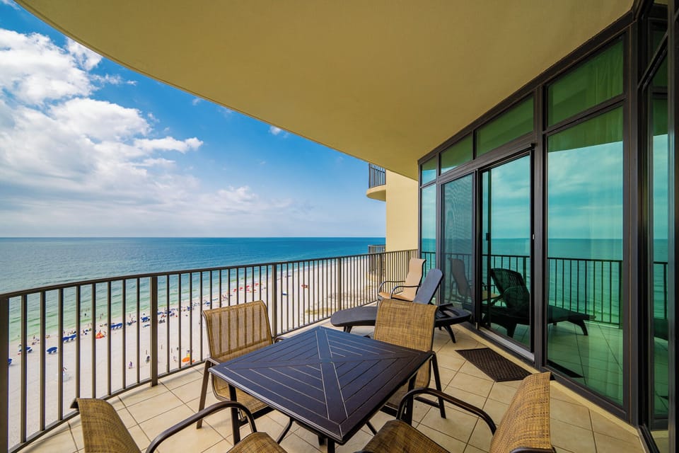 Relax on your balcony with a refreshing drink, soaking in the vibrant coastal views and sounds