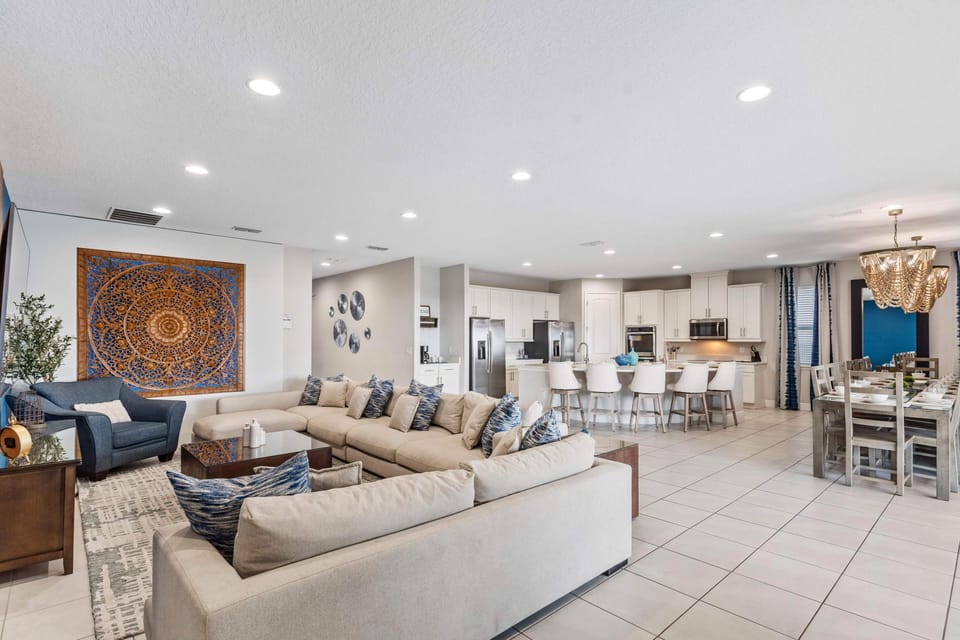 - Spacious living room with modern open floor plan  
- Plush sectional sofa seating for the whole group  
- Stylish décor leads into kitchen and dining area