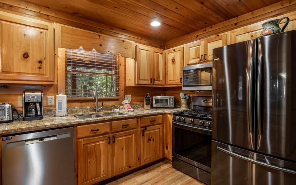 Angled view of kitchen; full-size appliances; thick, beautiful, veined granite