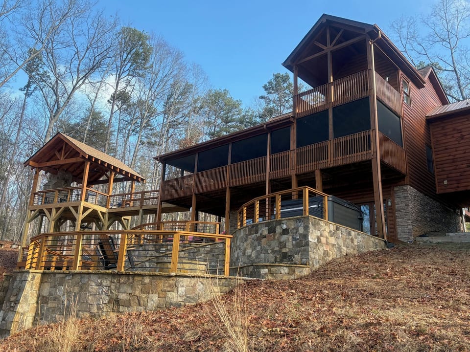 Looking up to the cabin with the hot tub on the flagstone patio.