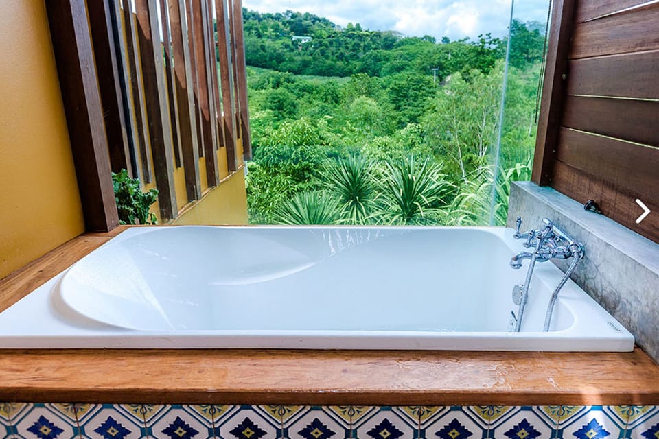 Deluxe balcony with bathtub | Bathroom | Shower, free toiletries, hair dryer, bathrobes