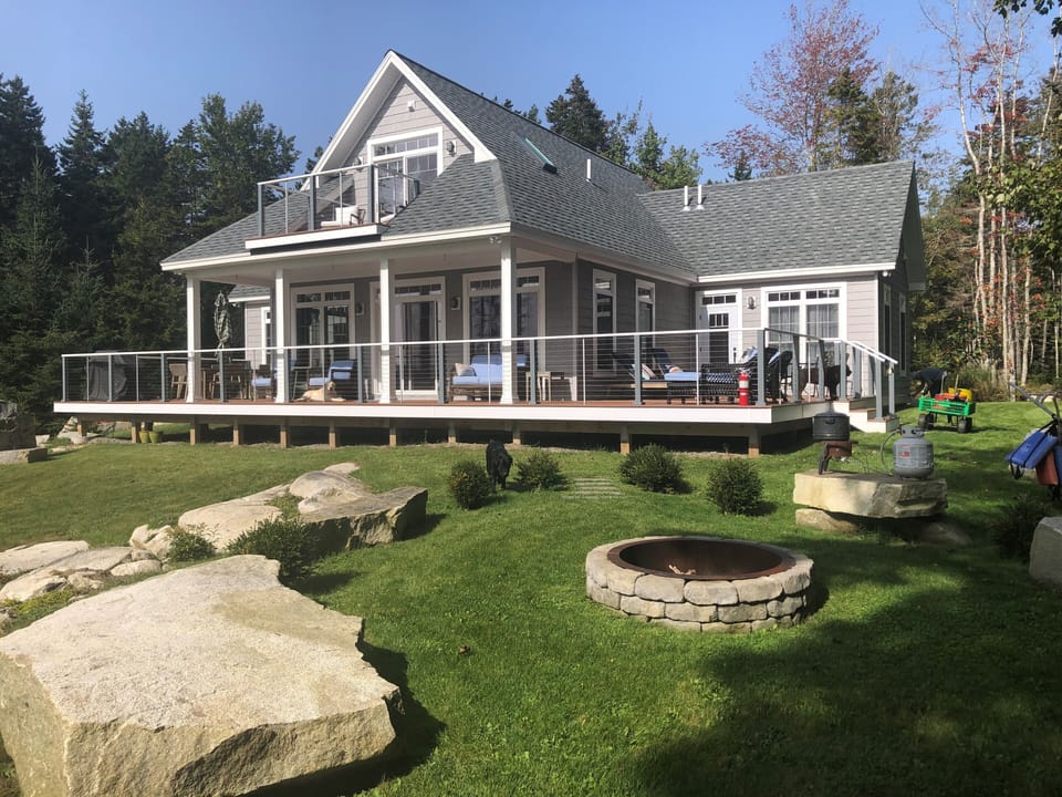 Front of house facing ocean with fire pit