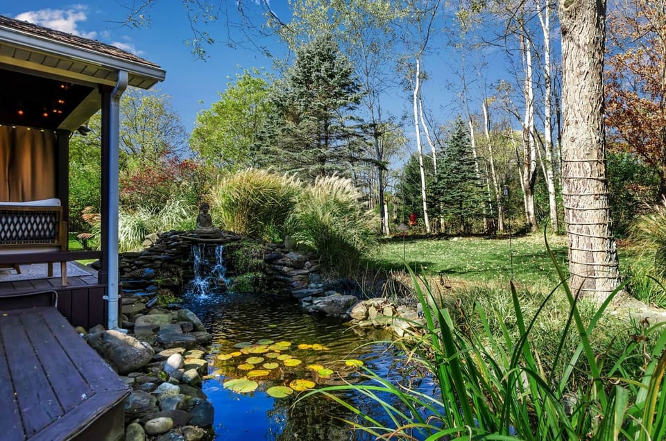 Peaceful koi pond and landscaped backyard add to the relaxing atmosphere