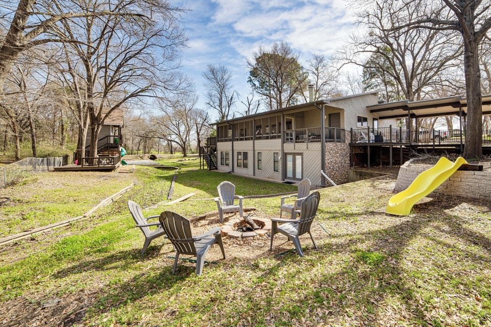 Back Exterior | Gas & Wood-Burning Fire Pits | Spacious Yard | Kids' Playset