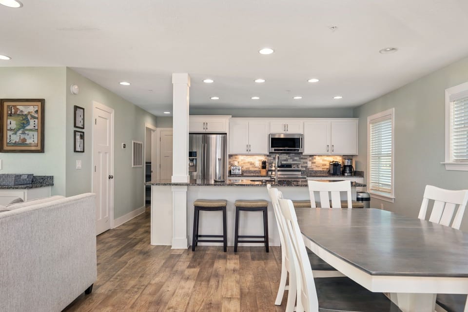 NH387F: Cape Hatteras Cottage | ML Living and Dining Area, Deck Access