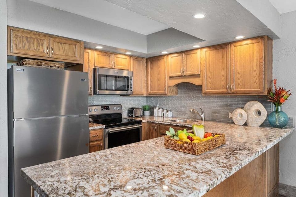 Updated kitchen with large granite counter tops at Papakea A108