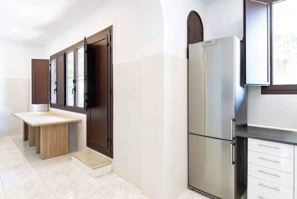 Modern hallway with wooden cabinetry and contemporary stainless appliances