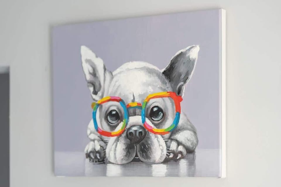 A quirky wall art of a French Bulldog with colorful glasses, adding a playful touch to the neutral décor.
