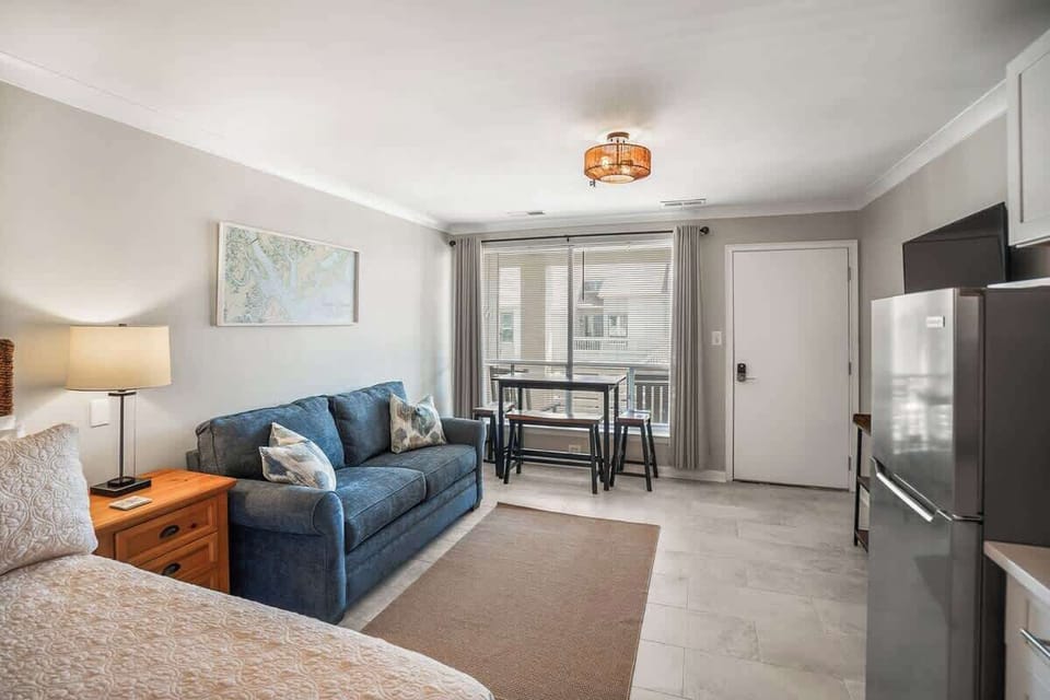 Living Room with Queen Sleeper Sofa, Queen Bed, Dining Table and Kitchen