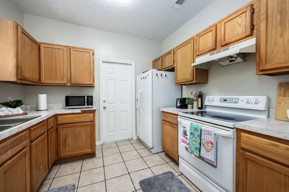 Fully equipped kitchen with ample cupboards and cabinets