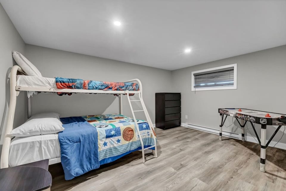 Bright basement room with bunk beds and entertainment.