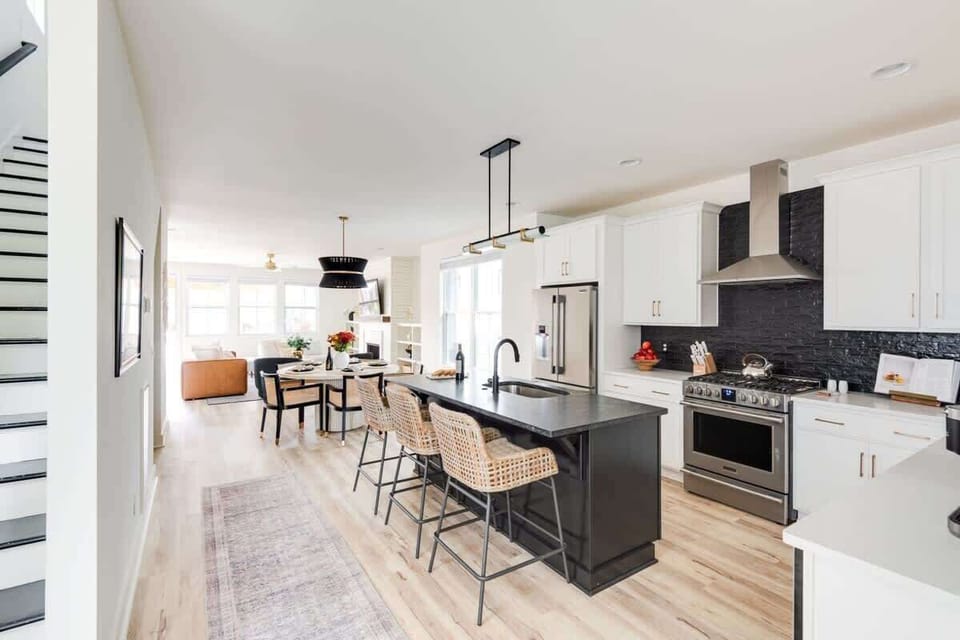 Clean and Spacious Kitchen with Sleek Countertops and Additional Seating