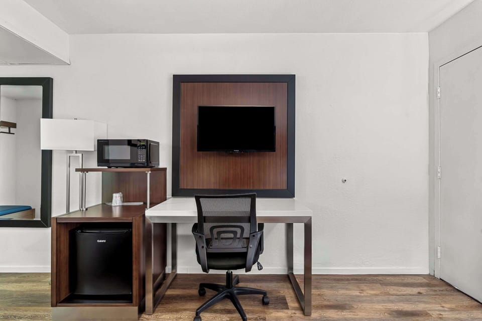 Premium bedding, desk, laptop workspace, blackout drapes