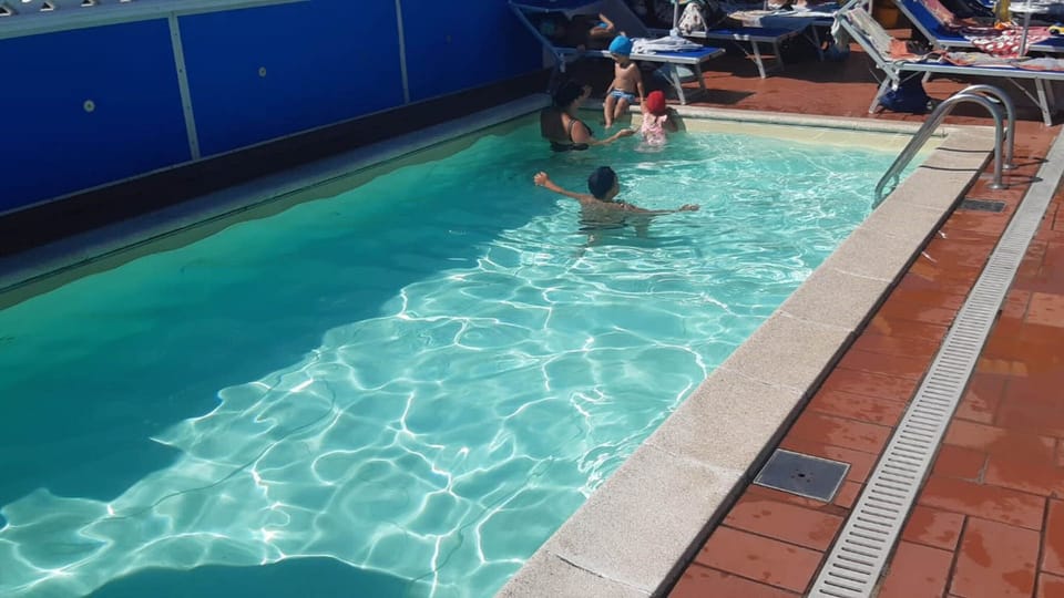 Seasonal outdoor pool, pool umbrellas, sun loungers