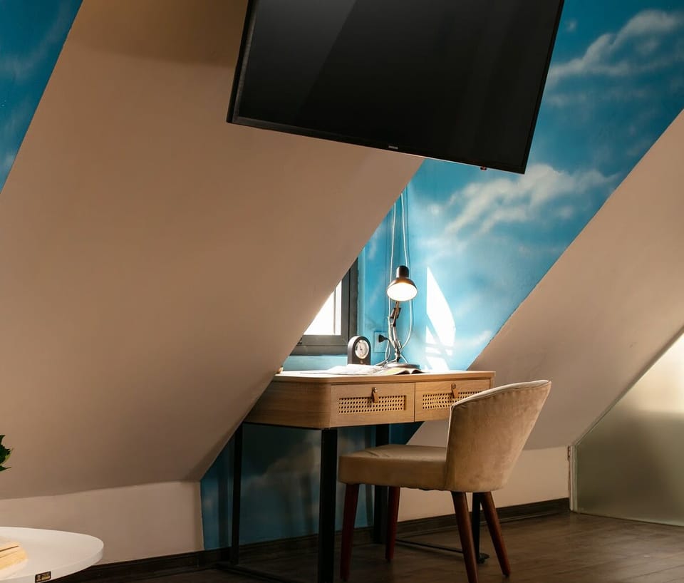 Premium Triple Room | Minibar, in-room safe, desk, blackout drapes