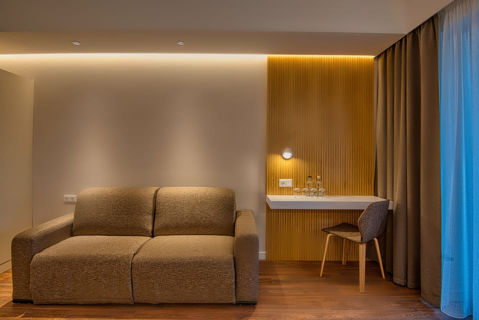 Deluxe Room | Living area | 108-cm LED TV with cable channels