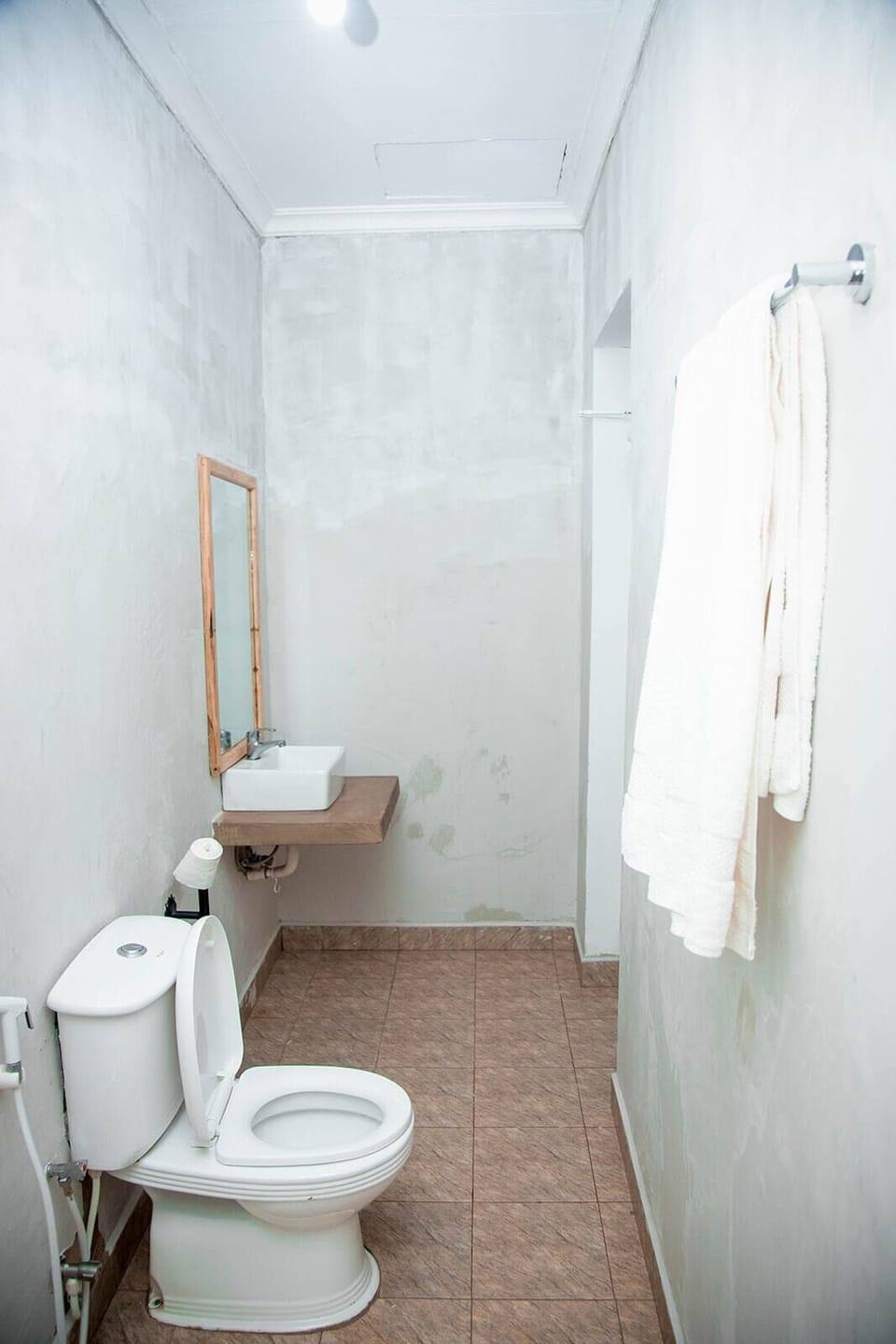 Shower, rainfall showerhead, slippers, towels