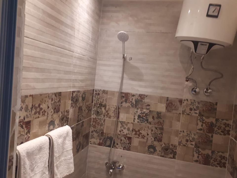 Designer toiletries, hair dryer, slippers, towels