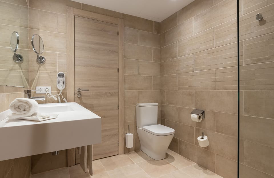 Shower, rainfall showerhead, hair dryer, towels