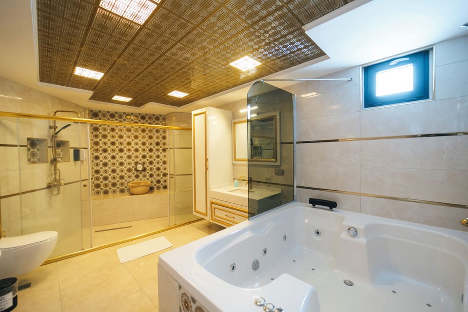 Exclusive Studio Suite, Jetted Tub, Garden View | Bathroom | Separate tub and shower, jetted tub, rainfall showerhead
