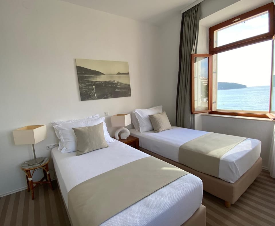 Family Room, 2 Bedrooms, Sea View | 1 bedroom, in-room safe, desk, iron/ironing board