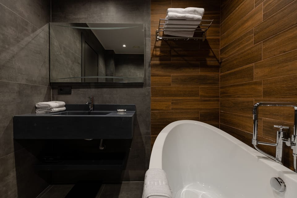 Deluxe Back View | Bathroom | Slippers, bidet, towels, soap