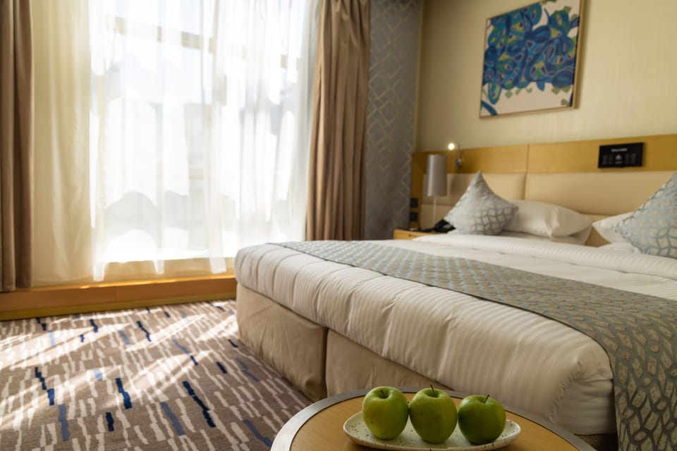 Family Suite | Minibar, in-room safe, blackout drapes, iron/ironing board