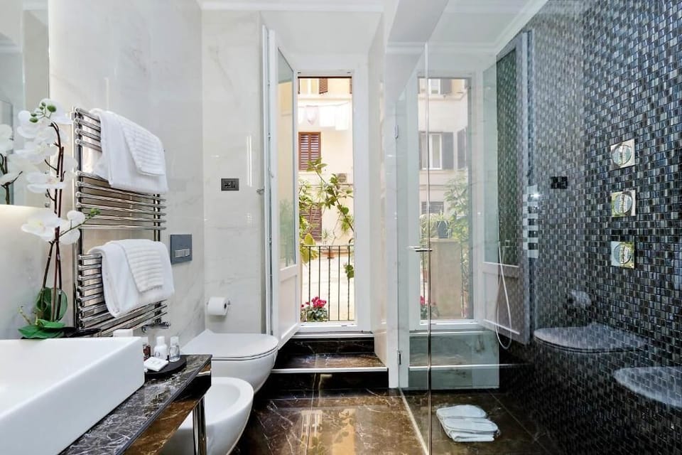 Classic Quadruple Room | Bathroom | Shower, hair dryer, slippers, towels