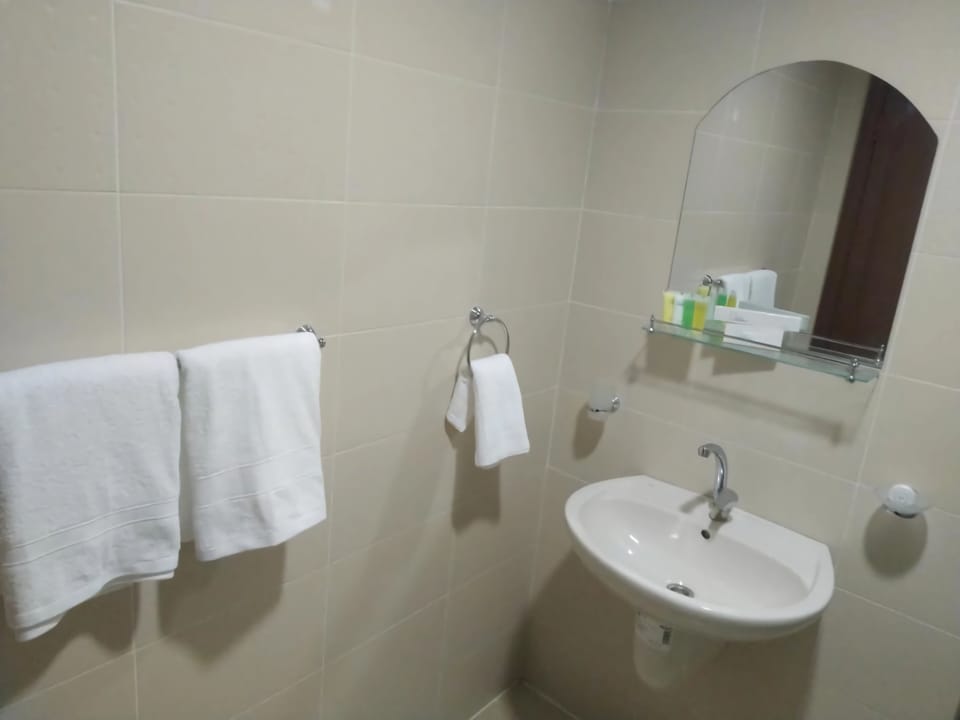 Combined shower/tub, designer toiletries, bathrobes, slippers