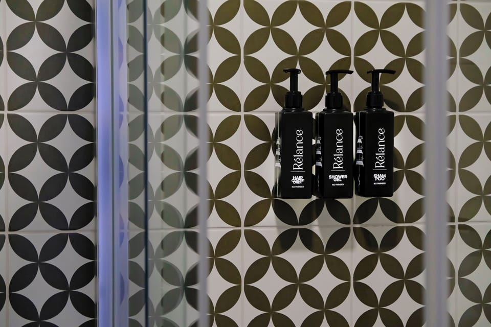 Shower, designer toiletries, hair dryer, bathrobes