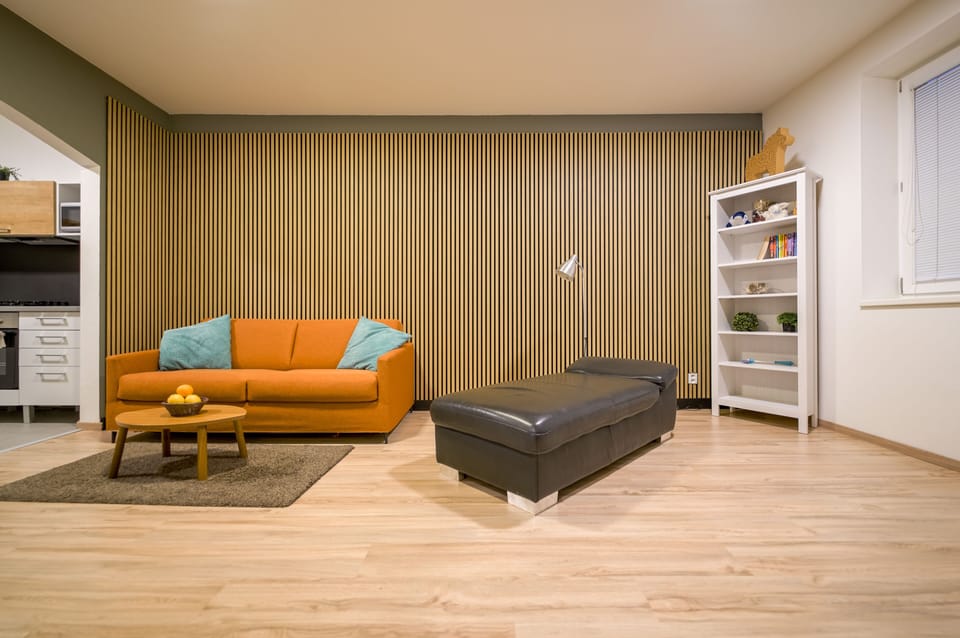 Vesna Convenient Apartment by CHORS | Living area | 102-cm flat-screen TV with satellite channels, TV
