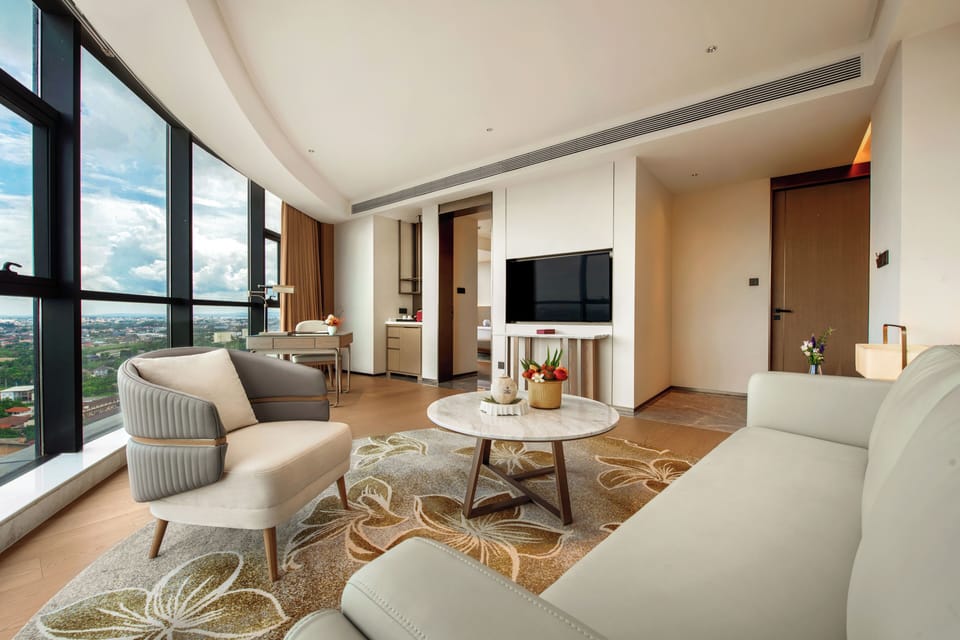 Deluxe Suite | Living area | 55-inch LCD TV with cable channels