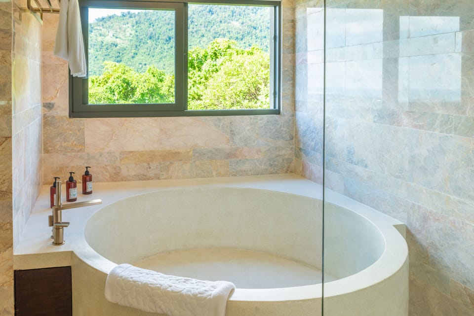 Separate tub and shower, hair dryer, slippers, towels