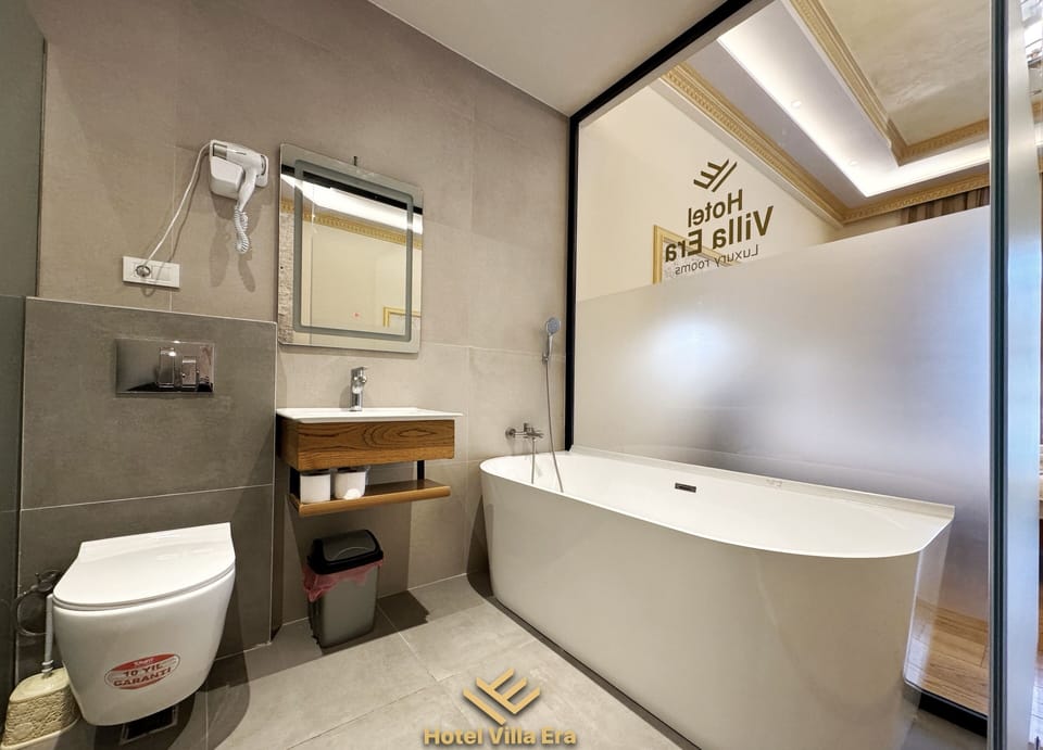 Deluxe Room, Fireplace, Poolside | Bathroom | Deep soaking tub, rainfall showerhead, free toiletries, hair dryer