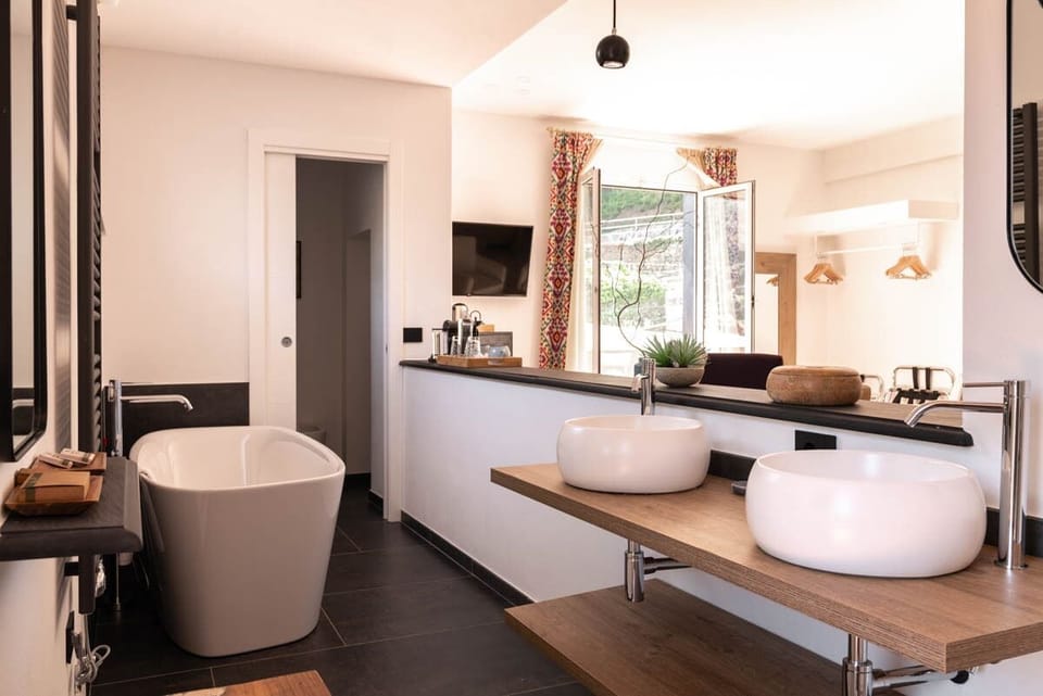 Suite, 1 Bedroom | Bathroom | Rainfall showerhead, hair dryer, bathrobes, slippers