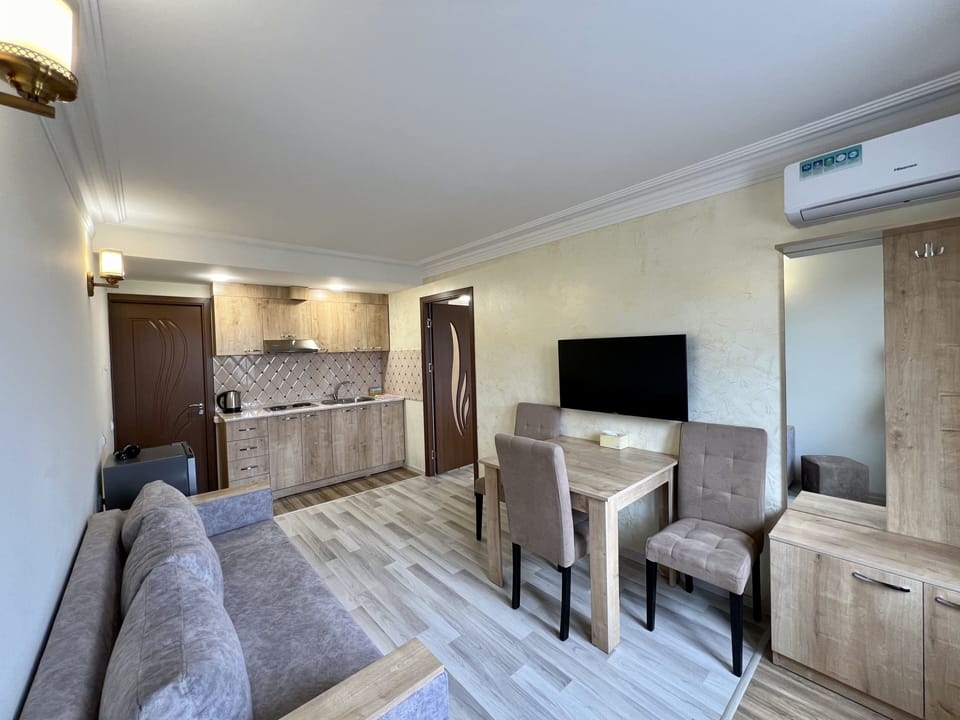 Deluxe Apartment | Living area | 100-cm LED TV with cable channels