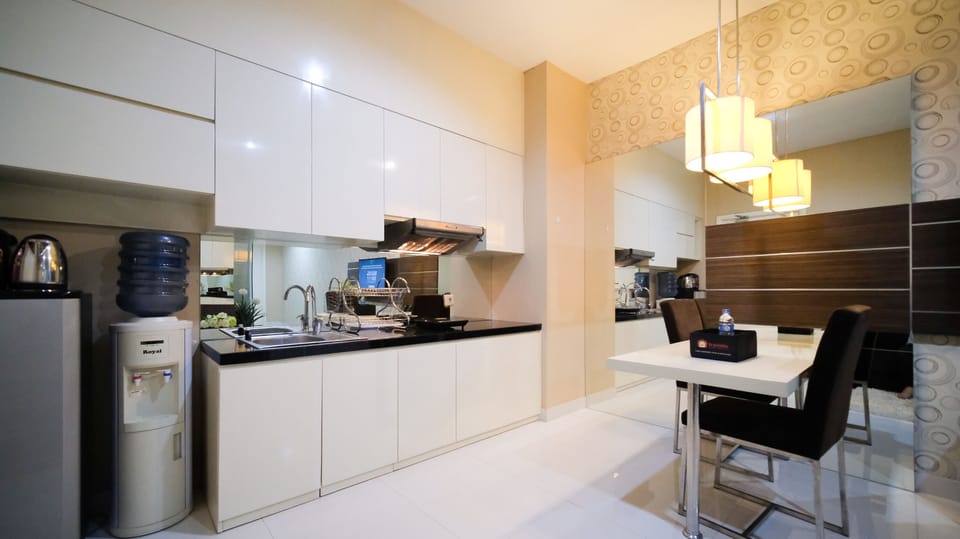 Apartment | Private kitchen | Fridge, stovetop, rice cooker, dining tables