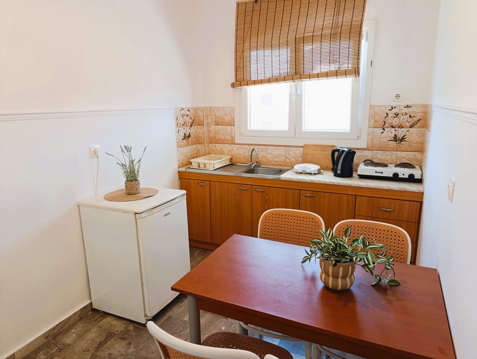 Family Apartment | Private kitchen | Full-size fridge, stovetop, electric kettle, highchair