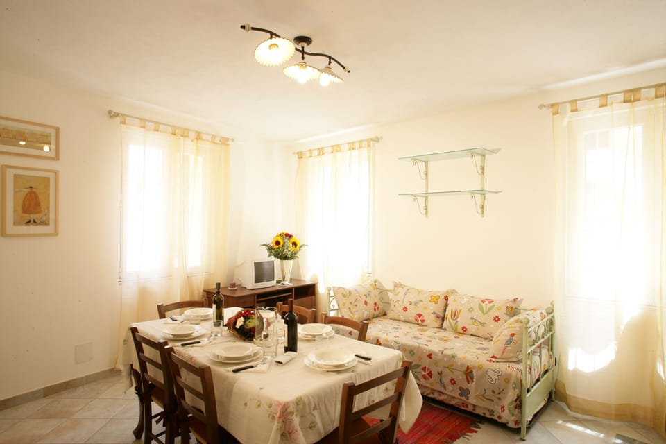 Apartment, 1 Bedroom, Balcony (Ginestra) | Living area | 25-inch flat-screen TV with satellite channels, TV, DVD player