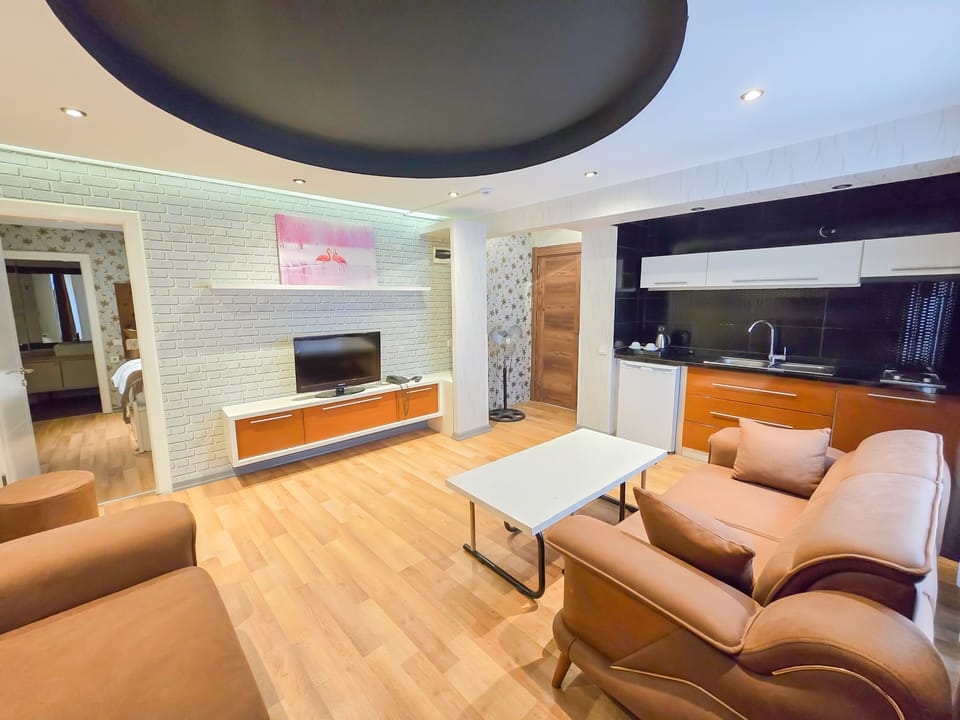 Family Suite | Living area | 30-inch LCD TV with cable channels, heated floors