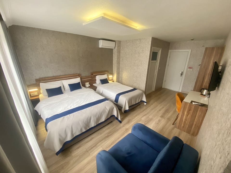 Deluxe Quadruple Room | Minibar, in-room safe, iron/ironing board, free WiFi