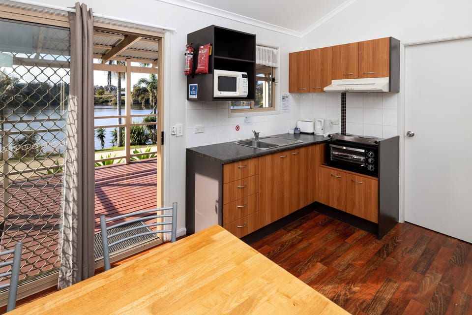 Standard Riverside 2 Bedroom Cabin | Private kitchen | Shared fridge, microwave, oven, stovetop