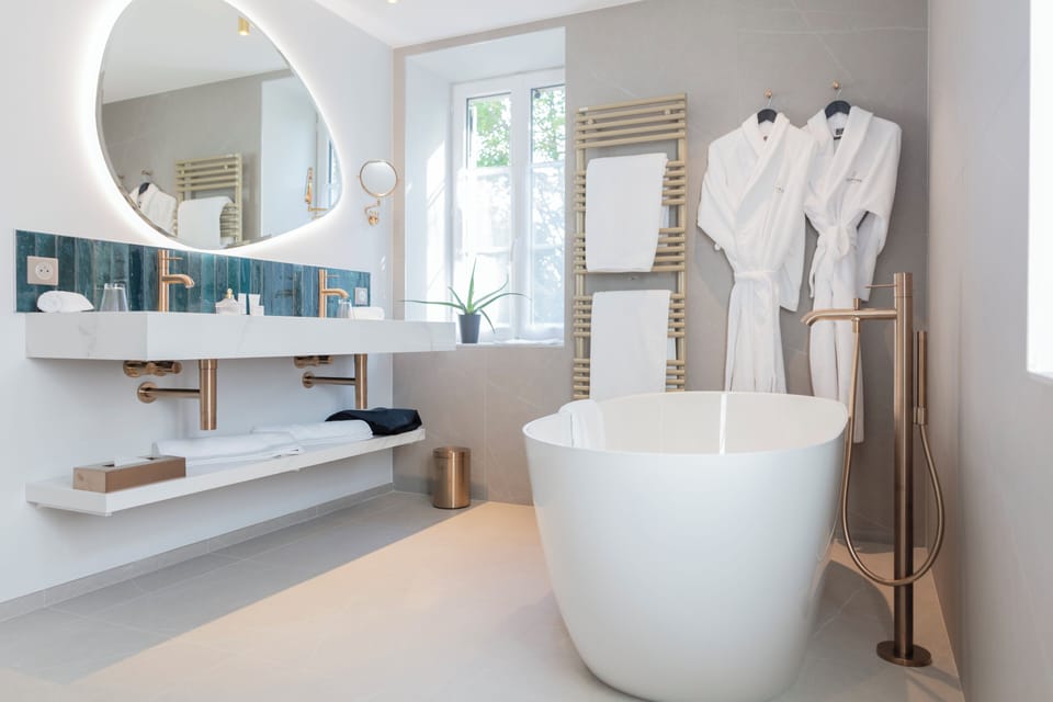 Suite, 1 King Bed with Sofa bed | Bathroom | Hair dryer, slippers, towels, soap